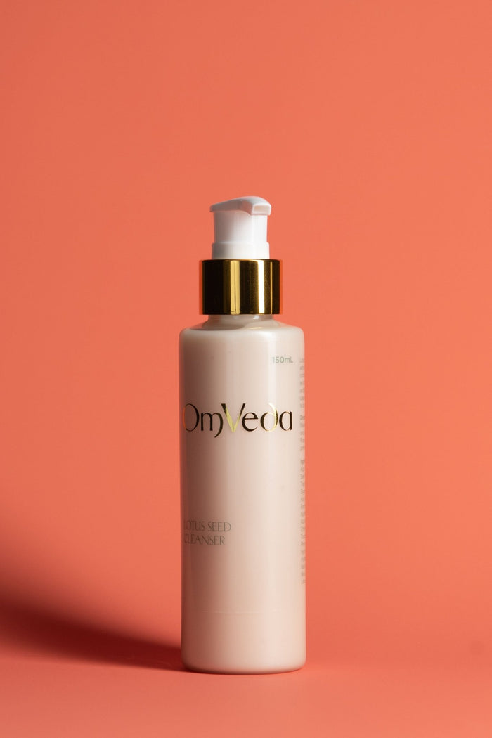 OmVeda lotus seed cleanser pump bottle with gold pump ring and white bottle