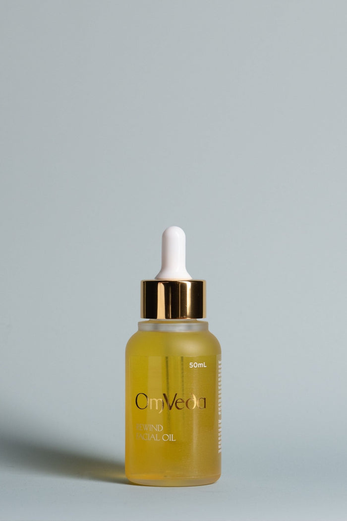 OmVeda Rewind facial oil bottle with dropper, amber-gold glass, 50 ml