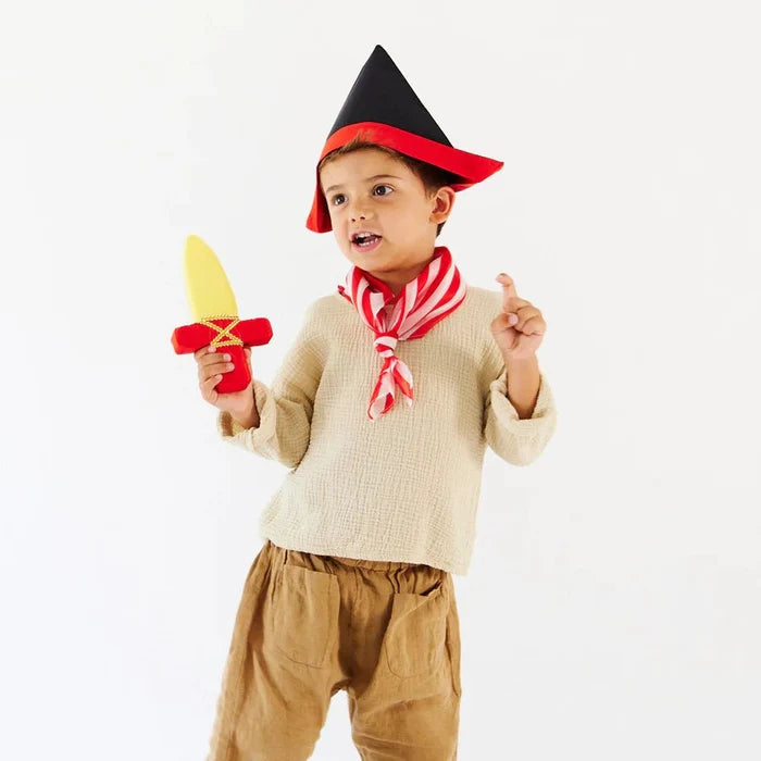 Child in a pirate costume, wearing a black pirate hat and carrying a red and yellow dagger