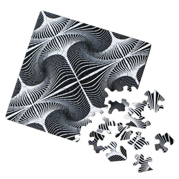 Black and white patterned puzzle with pieces scattered on a white background