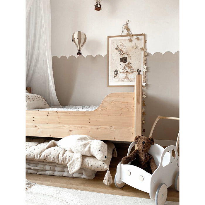 Children's room with wooden bed, Brown Senger teddy bear, and toys on a shelf.