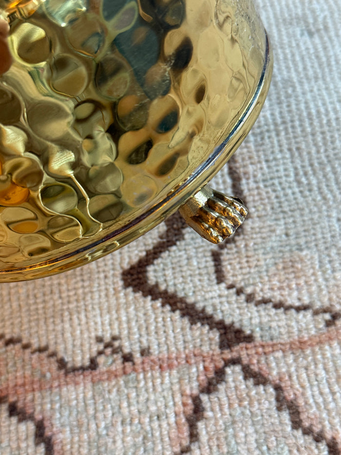 Close-up of a gold pocket watch on a textured fabric background