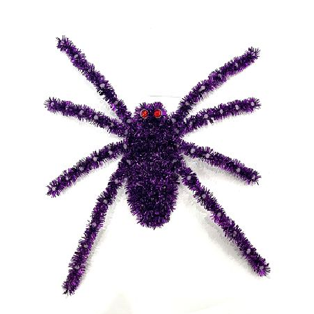 A purple tinsel spider decoration with red eyes, photographed against a plain white background.
