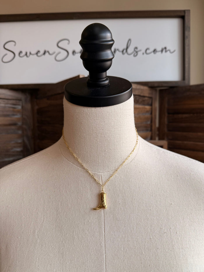 Gold plated cowgirl boot pendant necklace with V-link chain on a mannequin