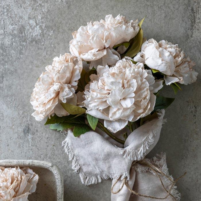 Bouquet of white flowers on a textured surface