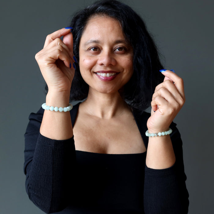 woman wearing green aquamarine bracelets