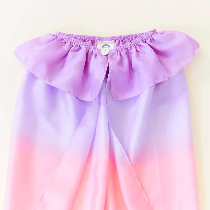 Gradient purple to pink silk cape with ruffled top and button closure on a white background