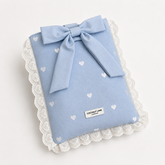 Blue fabric Book Sleeve with embroidered heart design, bow closure and white lace edging.