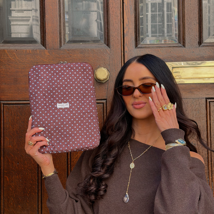Girl smiling holding the Brown and Blue Polka Dot iPad Case next to brown door