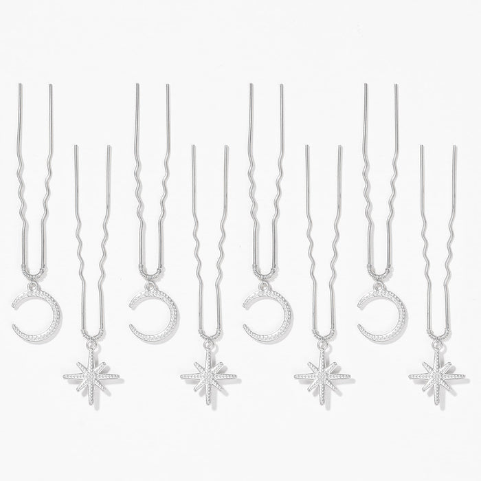 Sparkly star and moon U pins holding festival braid together with subtle celestial hair vibes