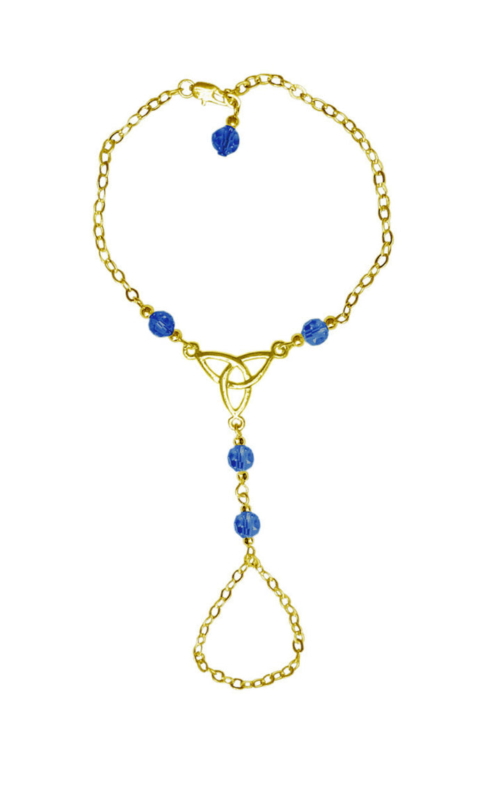 Gold Celtic trinity knot hand chain finger bracelet with blue bead accents front view