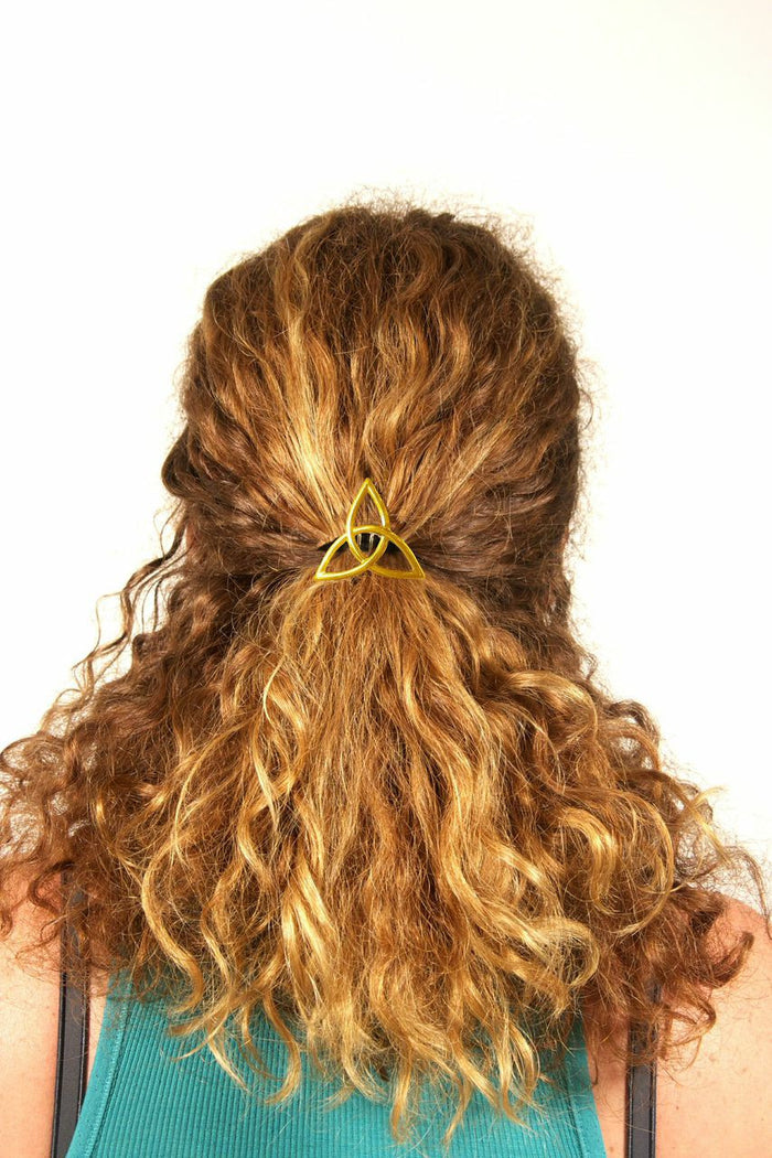 female model wearing the Hair Hook  gold Eternity knot for a ponytail holder