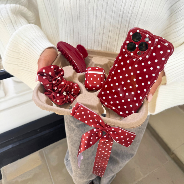 Coconut Lane gift set in a tray with a red polka dot phone case, matching scrunchie, and a cherry red claw clip.