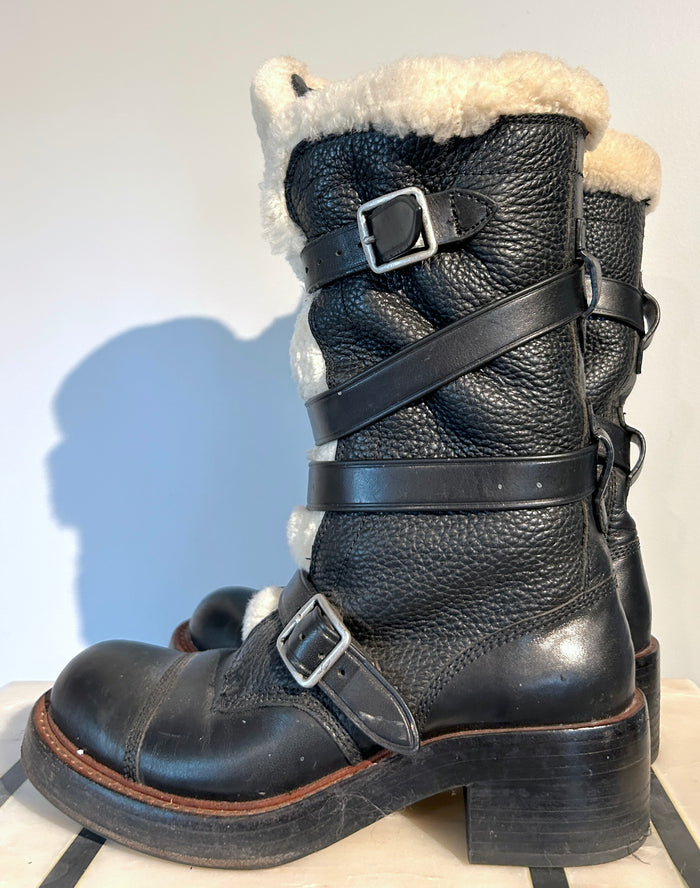 Coach shearling moto boots size 6.5, featuring black leather and cozy shearling lining, displayed on a white background.