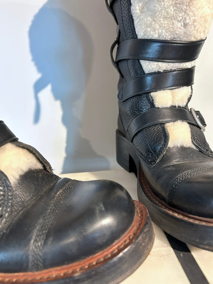 Coach shearling moto boots in size 6.5 with rugged design and cozy shearling lining, displayed on a neutral background.