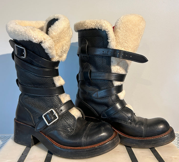 Coach shearling moto boots in size 6.5, featuring black leather and cozy shearling lining, displayed on a neutral background.