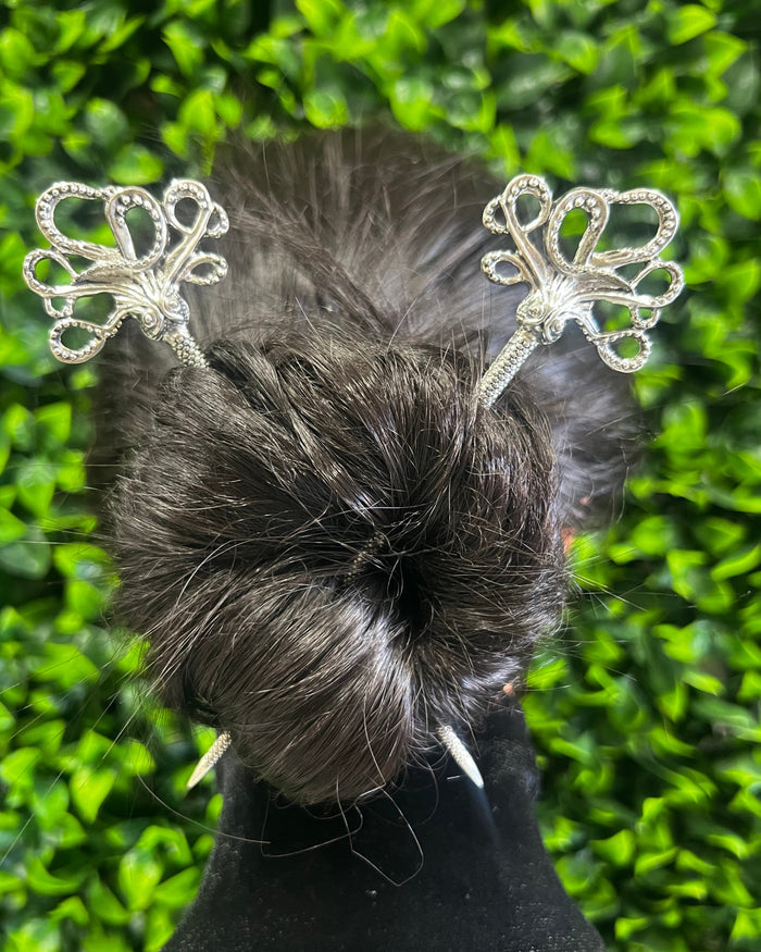 Silver Cthulhu octopus hair sticks securing a twisted bun hairstyle, featuring detailed tentacle-inspired metal design for fantasy, gothic and nautical hair styling.