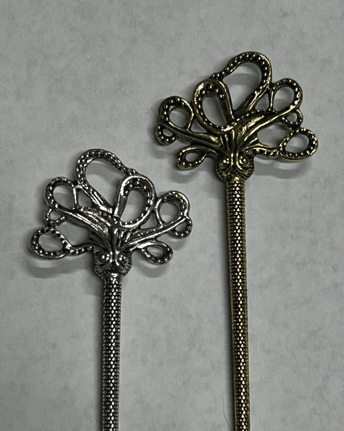 Cthulhu Hair Sticks shown side by side in silver and gold finishes, featuring a mystical octopus design for buns, updos, and twisted hairstyles.