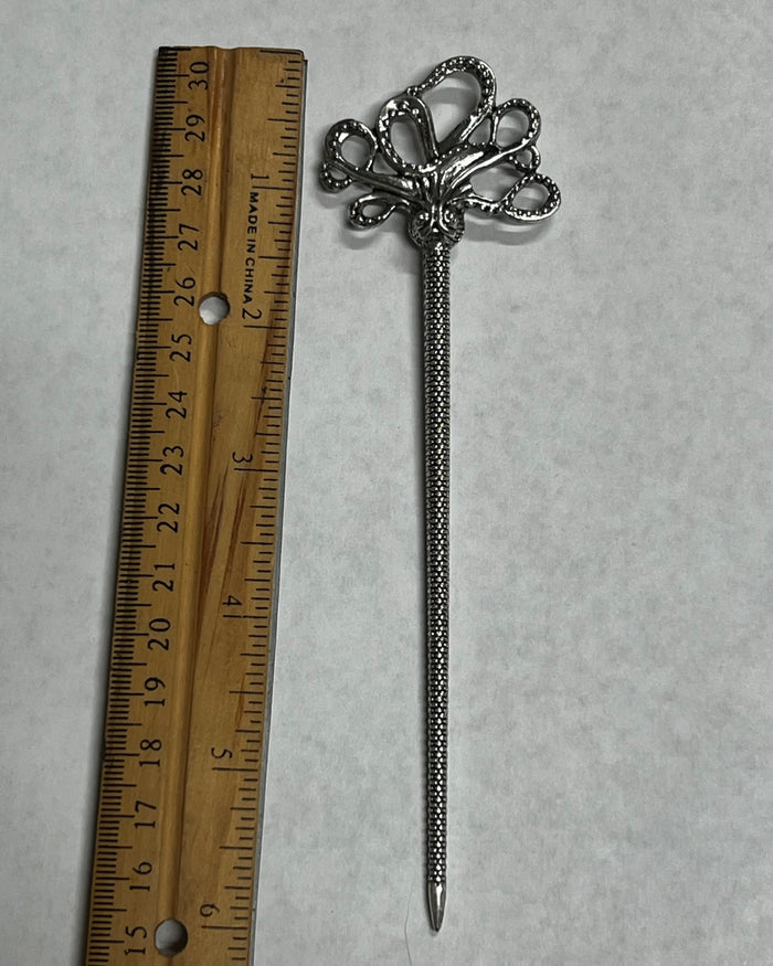 Silver Cthulhu Hair Stick with mystical octopus design shown beside a ruler for size reference, decorative metal hair accessory for buns, updos, and twisted hairstyles.