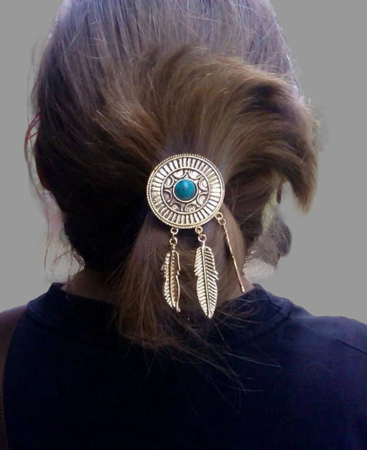 Model wearing gold dream catcher hair hook with turquoise stone and feather charms