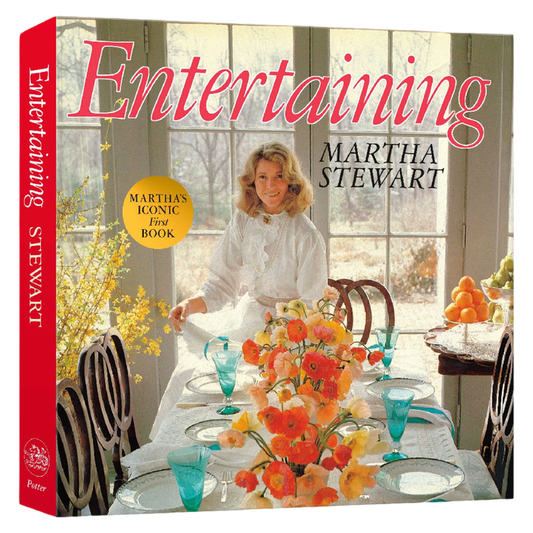 Book cover of 'Entertaining' by Martha Stewart with a woman setting a table.