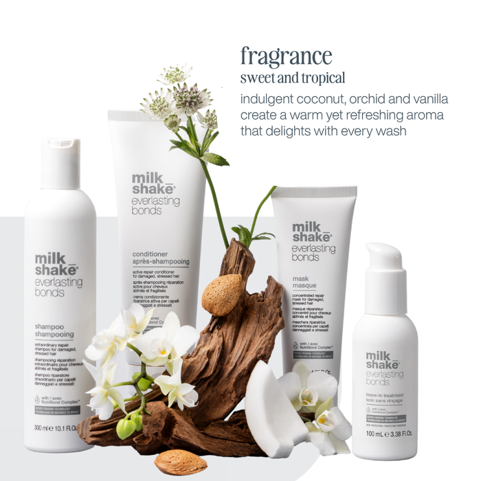 milk_shake everlasting bonds hair care products with flowers and driftwood on a white background