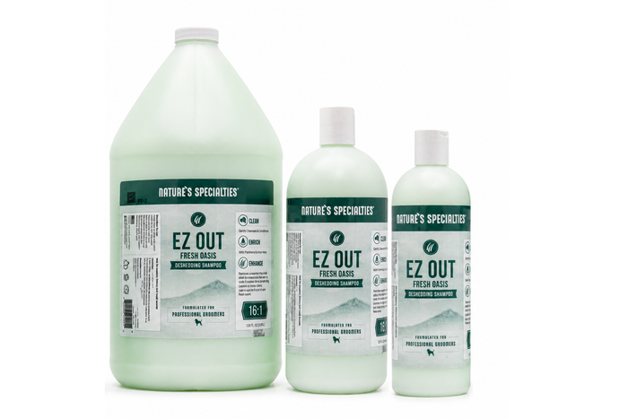 Three bottles of Nature's Specialties EZ OUT Deshedding Shampoo in different sizes: a 1-gallon jug, a 32 oz bottle, and a 64 oz bottle, all showing a pale green liquid inside, on a white background.