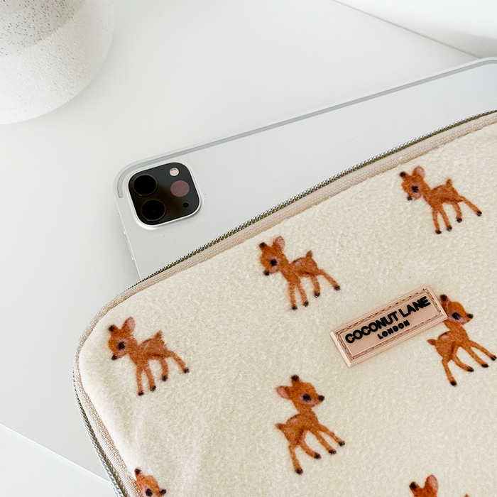 Coconut Lane iPad sleeve with small deer print in fleecy fabric next to a phone on a white surface.