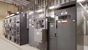 Commercial electrical control panels and wiring equipment installed in an industrial facility room interior