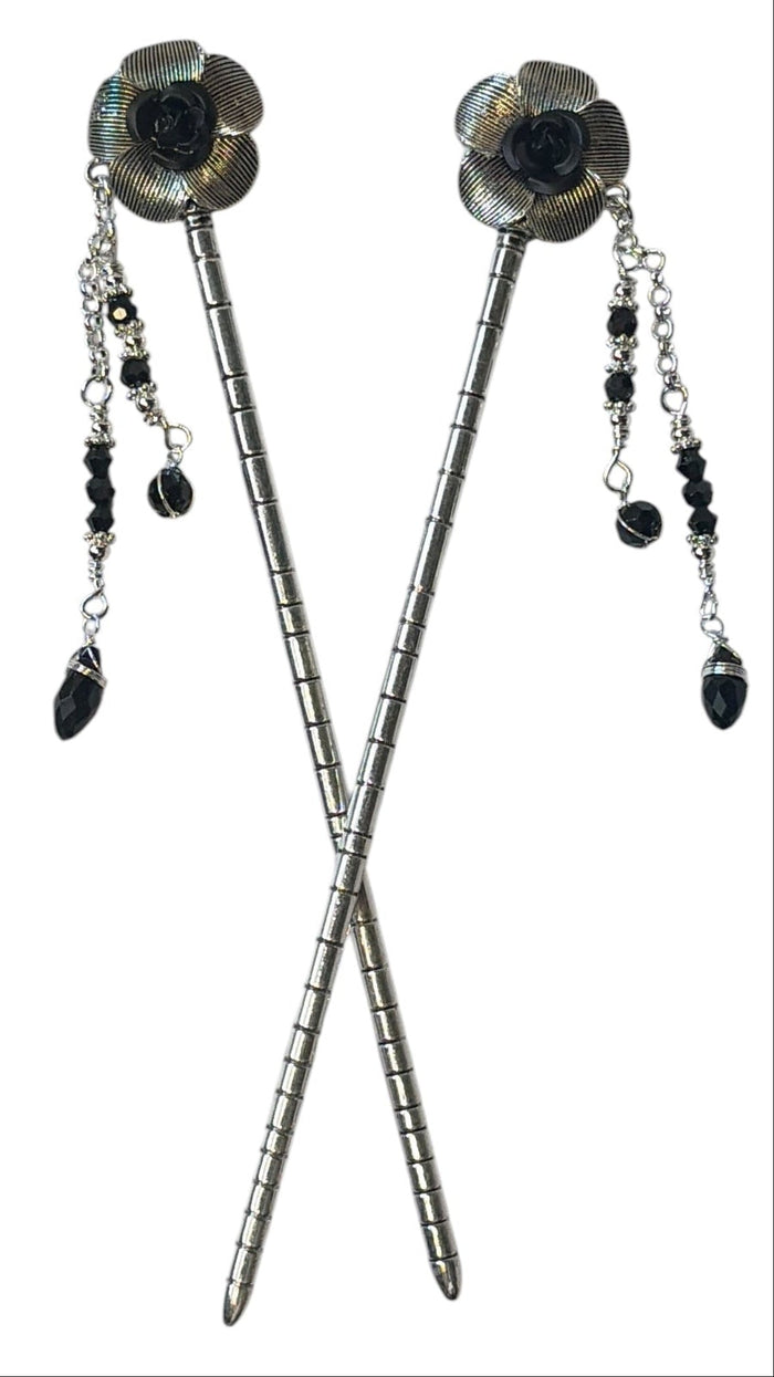 Pair of silver flower hair sticks with black rose centers and black crystal bead dangle chains, shown crossed on a white background to display the front view.
