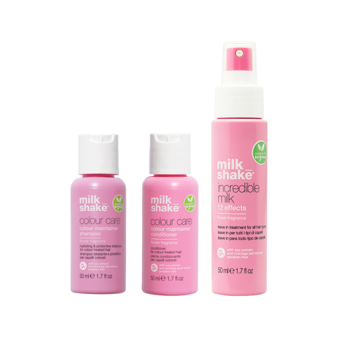 Three bottles of milk shake hair care products on a white background vegan flower vibes colour care, incredible milk