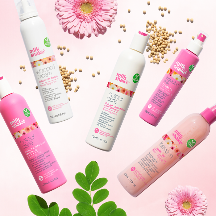 milk_shake hair care products on a pink background with flowers and leaves.