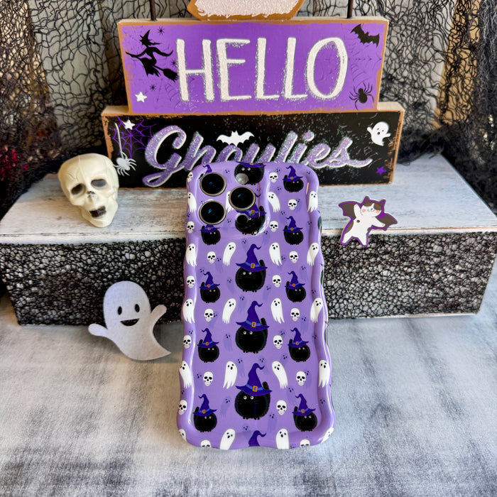 Back view of the Ghostly Whisker's Wavy Luxe MagSafe iPhone case propped against a HELLO Ghoulies sign showing the camera cutout.