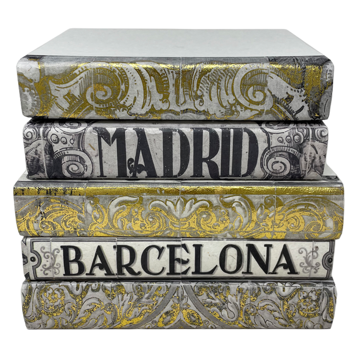 Stack of decorative books with 'Madrid' and 'Barcelona' on a white background