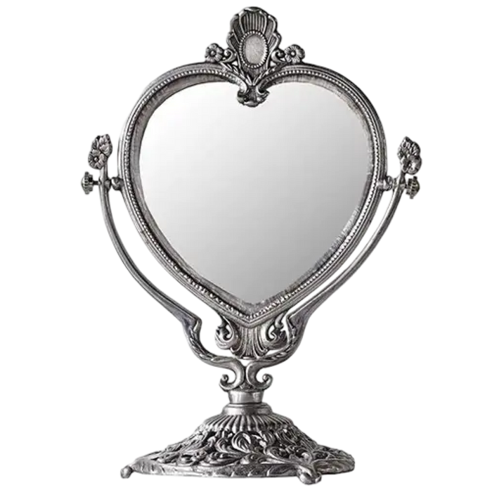 Decorative heart-shaped mirror with ornate frame on a white background