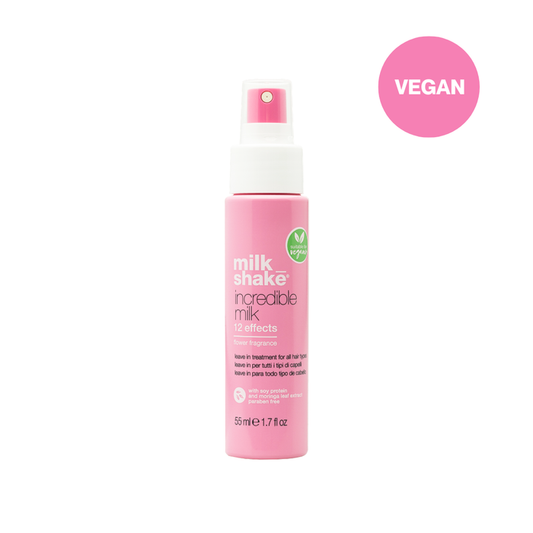 Pink spray bottle labeled 'milk shake' with a 'VEGAN' label on a white background