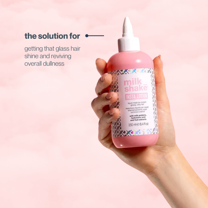 Hand holding a bottle of milk_shake product with text on a pink background