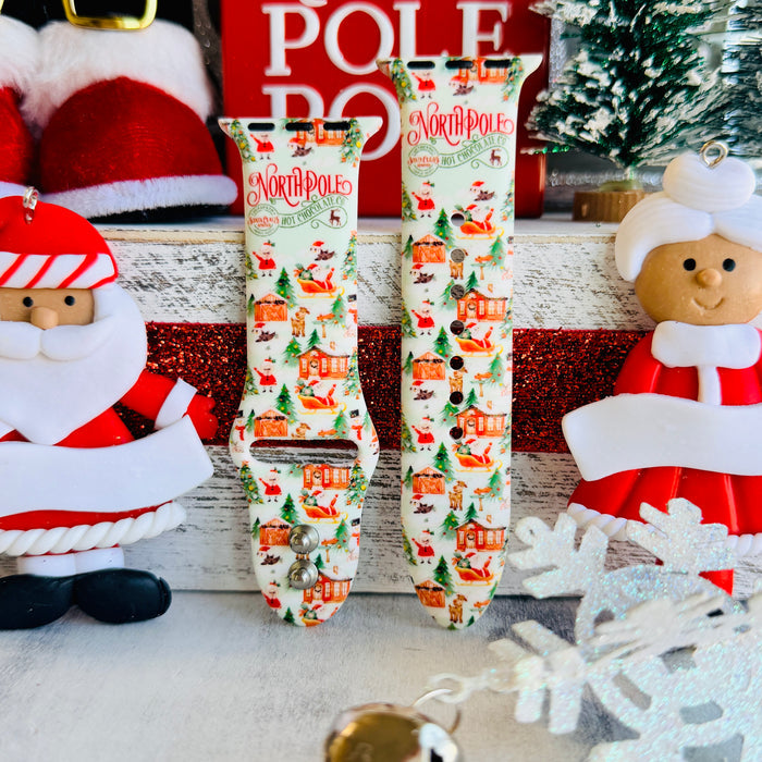 North Pole Apple Watch band with Santa's workshop, Christmas trees, and reindeer on cream background with North Pole sign