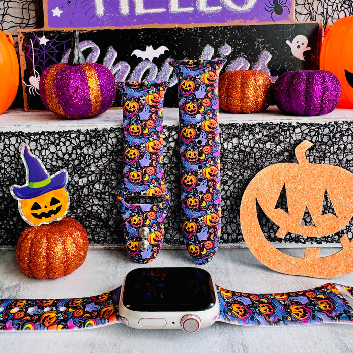 Jack-O-Lantern Jive silicone Apple Watch band hero shot in purple with glowing orange pumpkins and ghosts, shown with a rose gold Apple Watch.