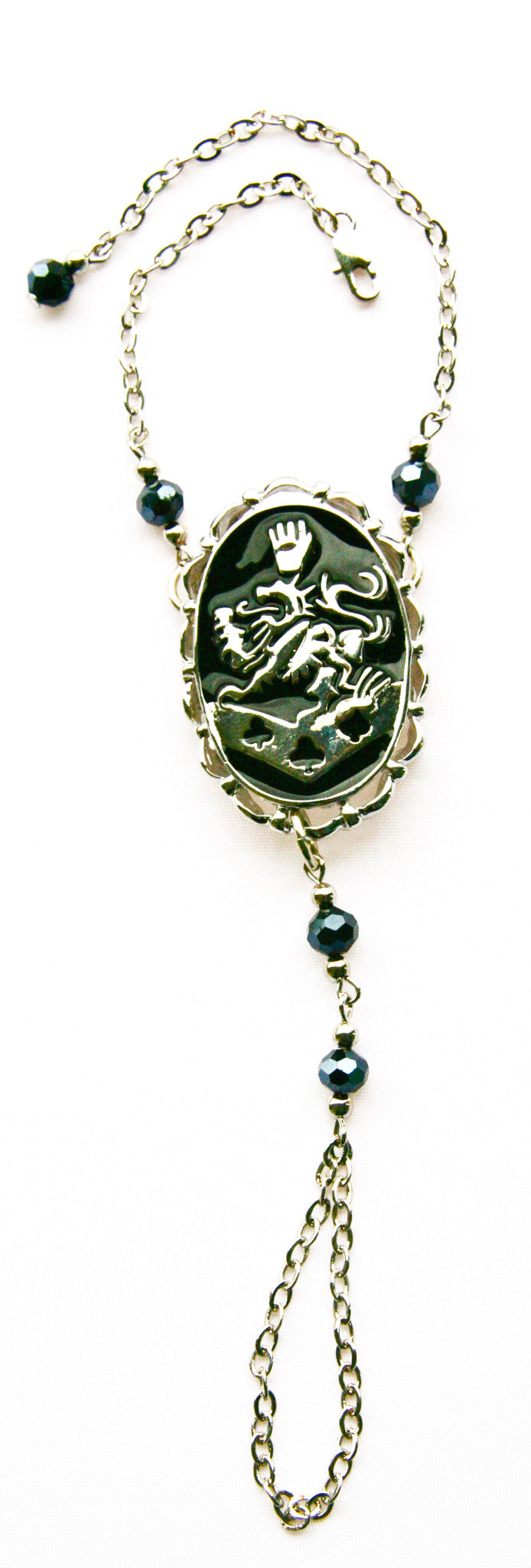 Kingdom crest gold-tone finger bracelet with chain, symbolic festival jewelry, front view on white background