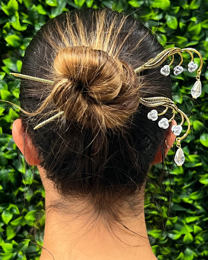 Leafy Flower Gems Hair Sticks worn in a bun hairstyle with clear crystal accents, rear view.