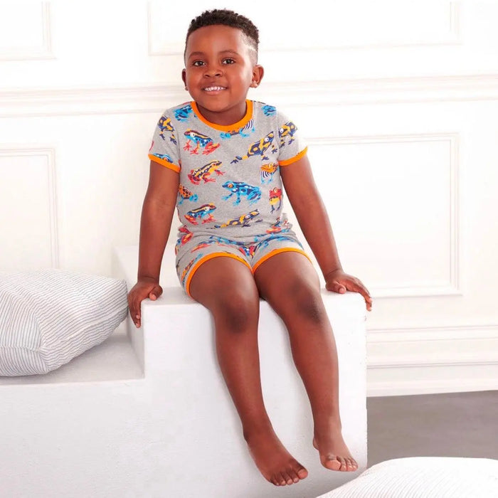 Boy wearing Hatley Leaping Frogs short pajamas with colorful frog print and soft organic cotton comfort.