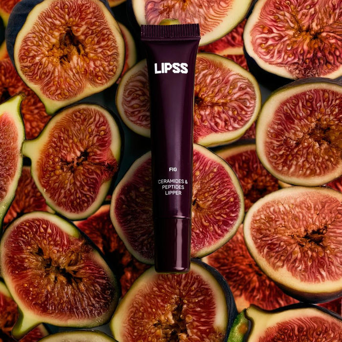Lip gloss tube Lipss Fig on a background of sliced figs