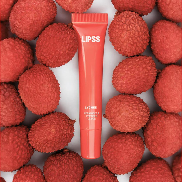 Lip gloss Lipss Lychee Spritz on a background of lychee fruits