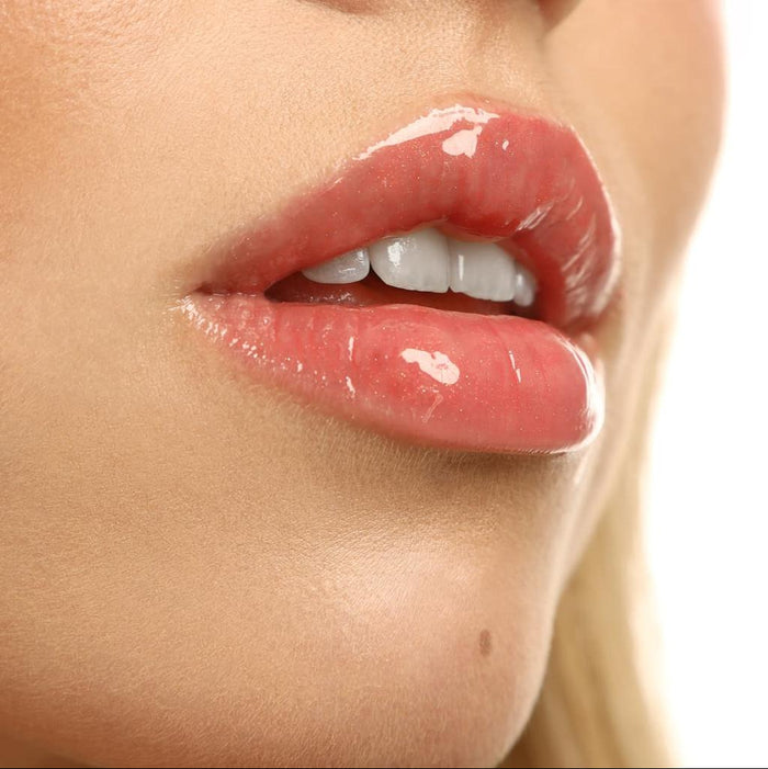 Close-up of glossy pink lips with a lip gloss Lipss Lychee Spritz