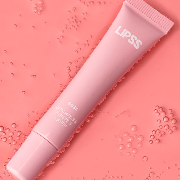 Pink Lipss lip gloss tube on a pink background with bubbles.