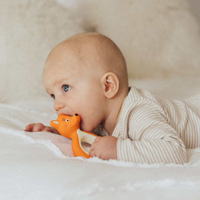 Baby with Mizzie The Kangaroo Mini Mizzie Baby Teether, a teether made from 100% natural rubber, designed to soothe sore gums naturally.