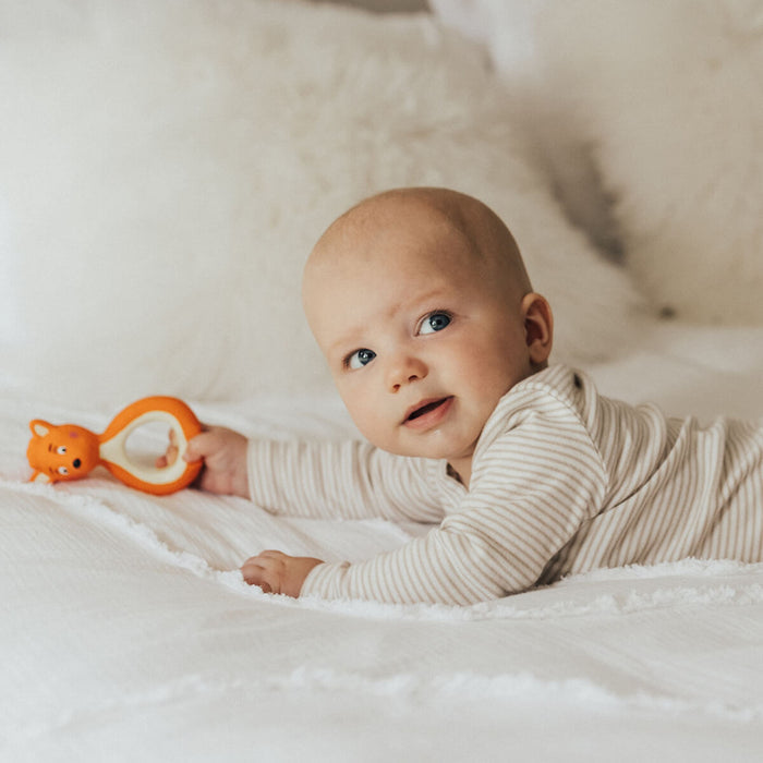 Baby with Mizzie The Kangaroo Mini Mizzie Baby Teether, a teether made from 100% natural rubber, designed to soothe sore gums naturally.