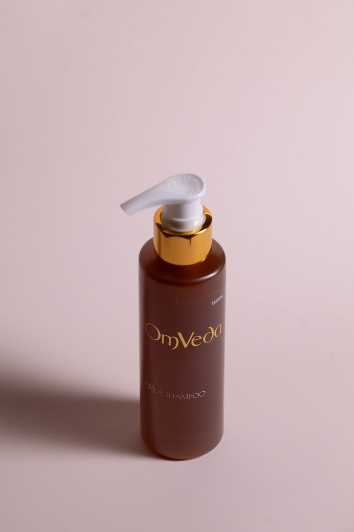 OmVeda amla shampoo bottle with white pump, brown bottle