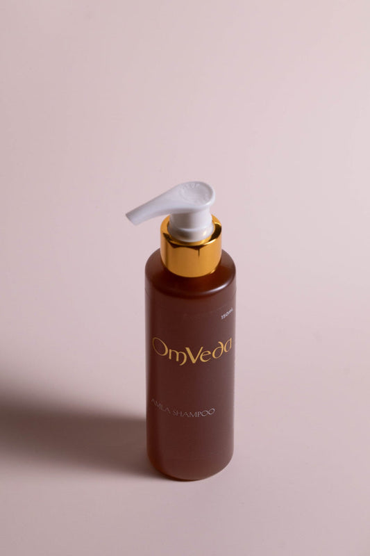 OmVeda amla shampoo bottle with white pump, brown bottle
